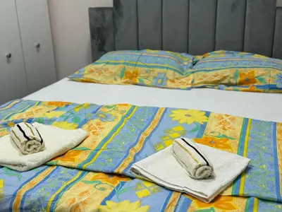 a bed with towels and pillows on top of it at Jelena in Vranje