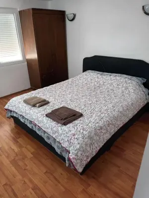 a bedroom with a bed with two towels on it at Apartman Bagdala in Kruševac
