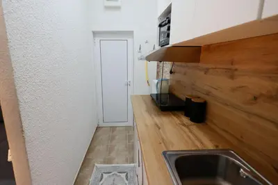 a kitchen with a sink and a wooden counter top at Ilić Sokobanja in Soko Banja