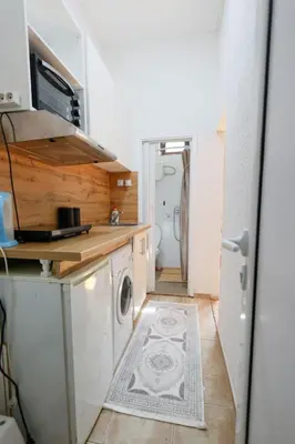 a kitchen with a washer and a washing machine at Ilić Sokobanja in Soko Banja