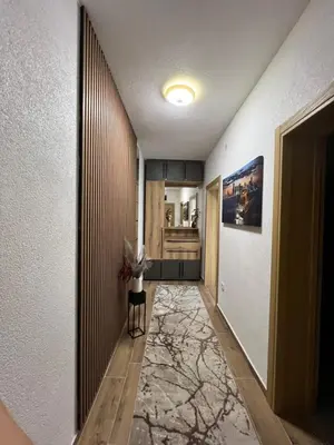 a hallway with a room with a vase on a table at Apartman Tina , kod hotela Sunce in Soko Banja