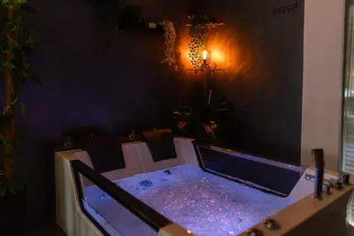 a table in a dining room with purple lights on it at SPA apartman Tomin adults only in Soko Banja