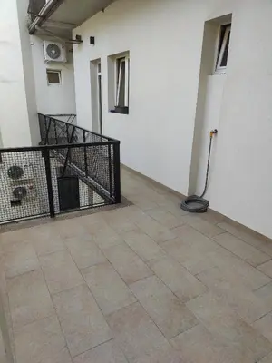 an empty room with a balcony with a vacuum at 
