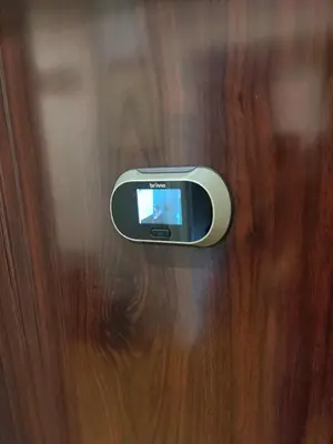 a close up of a cell phone on a wooden door at 