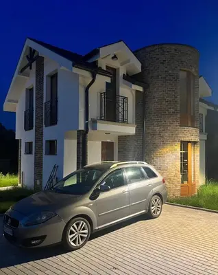 a silver car parked in front of a house at Royal Villa - HAWAII in Vrnjačka Banja