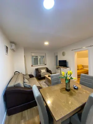 a living room with a dining table and a couch at Rtanj in Soko Banja