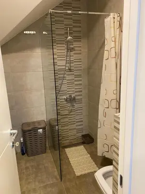 a shower with a glass door in a bathroom at Rtanj in Soko Banja