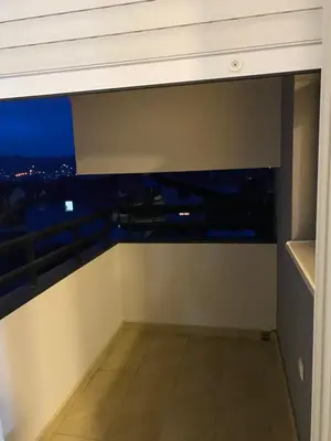 a room with a view of the city at night at Rtanj in Soko Banja