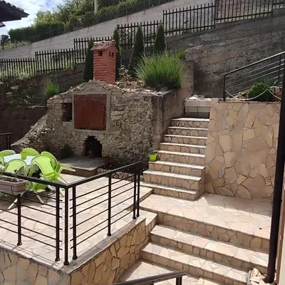 a set of stairs with a fireplace in a yard at Sokobanja na dlanu in Soko Banja