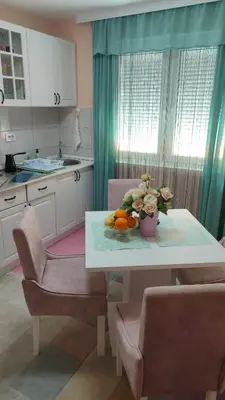 a kitchen with a table with a bowl of fruit on it at Sokobanja na dlanu in Soko Banja