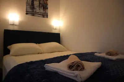 a hotel room with two towels on a bed at ADA Vrnjacka Banja in Vrnjačka Banja