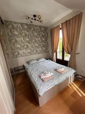 a bedroom with a bed with two towels on it at Royal King Villa 2 in Vrnjačka Banja