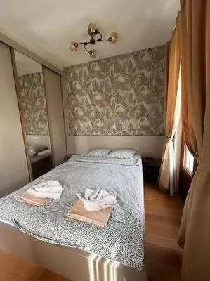 a bedroom with a bed with two towels on it at Royal King Villa 2 in Vrnjačka Banja