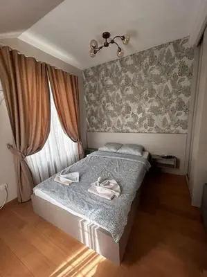 a small bedroom with a bed and a window at Royal King Villa 2 in Vrnjačka Banja