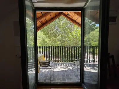 a sliding glass door leading to a patio at Lola in Prolomska Banja