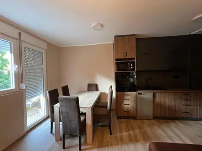 a kitchen and dining room with a table and chairs at Apartman Dašić in Jagodina