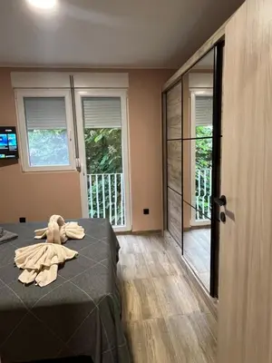 a room with a bed with a stuffed animal on it at Apartman Dašić in Jagodina