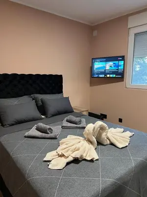 a stuffed animal is laying on a bed at Apartman Dašić in Jagodina