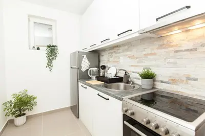 a kitchen with a sink and a counter at New Apartment in Vrnjačka Banja