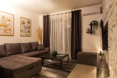 a living room with a couch and a table at New Apartment in Vrnjačka Banja