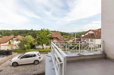 a small car parked on the balcony of a house at New Apartment in Vrnjačka Banja