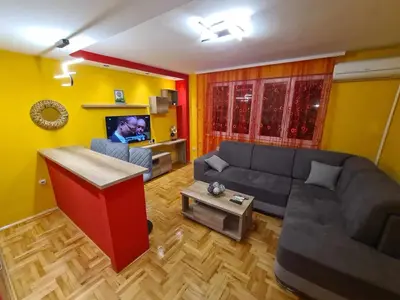 a living room with a couch and a table at Stan na dan Braca in Niš