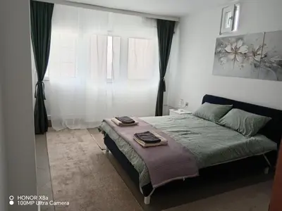 a bedroom with a bed and a window at Apartman predah Vranje FREE PARKING U SKLOPU JEDINICE in Vranje