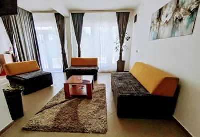 a living room with two couches and a coffee table at Apartman predah Vranje FREE PARKING U SKLOPU JEDINICE in Vranje