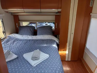 a bedroom with two beds with towels on it at Tomiceva Koliba Rtanj 2 in Rtanj