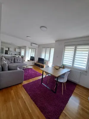 a living room with a couch and a table at Apartman Iva in Pirot