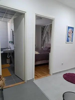a room with a door leading to a bedroom at Apartman Iva in Pirot