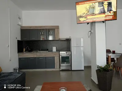 a kitchen with a white refrigerator and a tv at Predah in Vranje