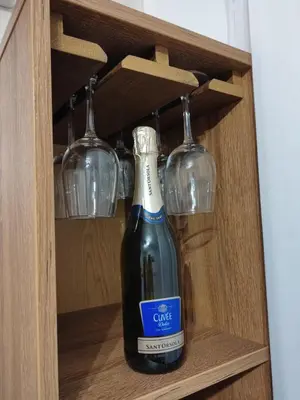 a bottle of wine in a cabinet with wine glasses at Apartman Marla Vrnjacka Banja in Vrnjačka Banja