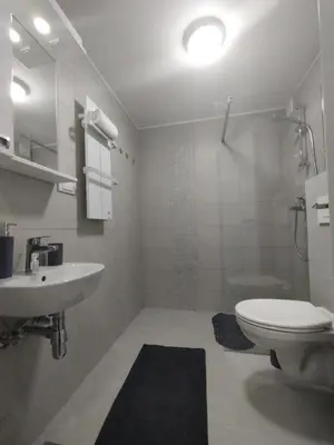 a bathroom with a white toilet and a sink at Apartman Marla Vrnjacka Banja in Vrnjačka Banja