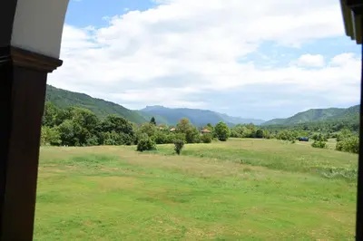 a view of a field with mountains in the background at Kod Bogdanovica in Vrtovac