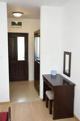 an office with a desk and a door with a chair at Kod Bogdanovica in Vrtovac