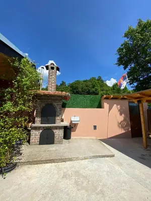 a brick oven in a driveway with a house at Vikvid in Nišor