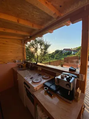 a kitchen with a stove and a large window at Vikvid in Nišor