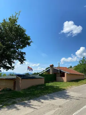 a house with a flag on top of it at Vikvid in Nišor