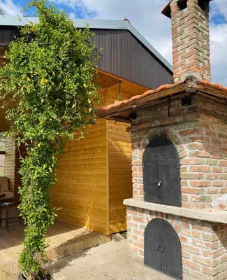 a brick building with a brick oven with a tree at Vikvid in Nišor