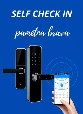 a hand holding a cell phone and a remote control at Apartman North resort in Vrnjačka Banja