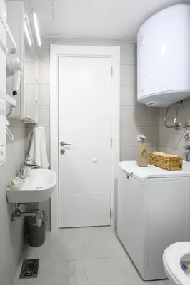 a bathroom with a white door and a sink at Apartman North resort in Vrnjačka Banja