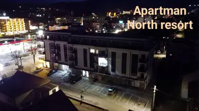 a building in a city at night with the words elephant north resort at Apartman North resort in Vrnjačka Banja