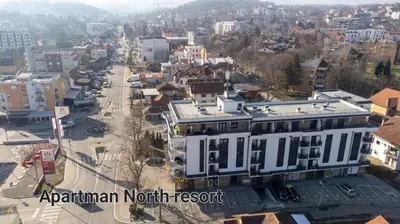 an aerial view of a city with a white building at Apartman North resort in Vrnjačka Banja