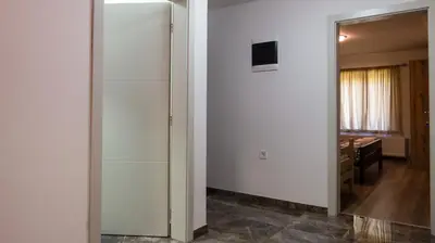 a hallway with a mirror and a room with a desk at Lesnik vacation home in Despotovac