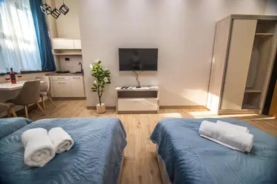 a bedroom with two beds with towels on them at Apartmani Monero in Vrnjačka Banja
