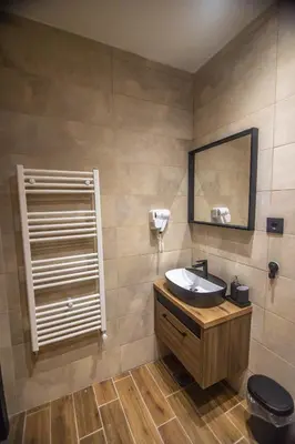 a bathroom with a sink and a mirror at Apartmani Monero in Vrnjačka Banja