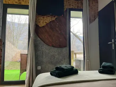 a bedroom with two towels on a bed with a window at Krupajsko vrelo in Milanovac