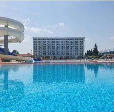 a large pool of water with a building in the background at leoben in Jagodina