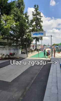 a sign for a park on the side of a street at leoben in Jagodina